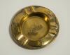 &lsquo;Ashes&rsquo;. Brass ashtray with title impressed to centre, to side rims images of a kangaroo with bat under his arm and lion tossing a ball into the air and to lower rim a set of three stumps and cricket ball. 3.75&rdquo; diameter. Some wear otherwise in good condi