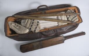 Leather cricket bag and kit. An early leather cricket bag containing a full size bat by Cobbett of Marylebone with serial number D.50291 stamped to rear splice. A pair of &lsquo;Tony Lock Junior&rsquo; size 8 canvas cricket boots, hardly used. Also two pairs of batti