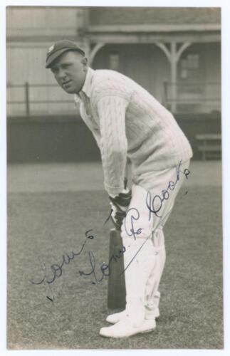 Thomas Edwin Reed &lsquo;Tommy&rsquo; Cook. Sussex 1922-1937. Sepia real photograph plain back postcard of Cook standing full length in batting pose wearing Sussex cap. Signed in ink to the photograph by Cook. Official stamp to verso for Albert Wilkes & Son, West Bro