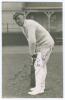 Thomas Edwin Reed &lsquo;Tommy&rsquo; Cook. Sussex 1922-1937. Sepia real photograph plain back postcard of Cook standing full length in batting pose wearing Sussex cap. Signed in ink to the photograph by Cook. Official stamp to verso for Albert Wilkes & Son, West Bro