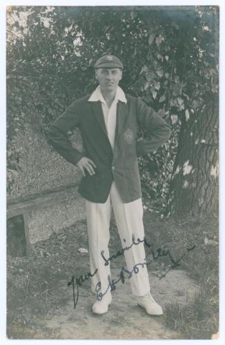 Edward Henry &lsquo;Ted&rsquo; Bowley. Sussex, Auckland & England 1912-1934. Mono real photograph postcard of Bowley standing full length under a tree wearing blazer and Sussex cap. Very nicely signed in black ink to the photograph by Bowley. Nias of Brighton. Postal