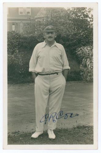 George Rubens Cox (George Cox Senior). Sussex 1895-1928. Sepia real photograph postcard of Cox standing full length wearing cricket attire and Sussex cap, hands in pockets. Very nicely signed in ink to the photograph &lsquo;G.R. Cox. Official stamps to verso fo