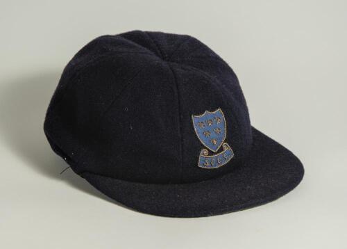 Stuart James Storey. Surrey and Sussex 1960-1978. Sussex navy blue 1st XI cloth cricket cap worn by Storey during his playing career. The cap,embroidered with the six martlet&rsquo;s emblem of Sussex to front. Name handwritten to inner label. Sold with a signed