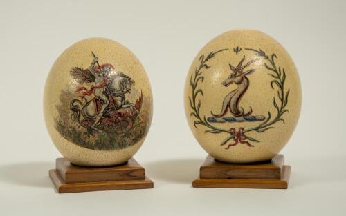 George Benjamin Street, Sussex & England 1909-1923. A pair of hand-decorated ostrich eggs, one decorated with the M.C.C. emblem of St. George and the dragon and the other with the South African emblem of the Springbok. The eggs were presented to George St