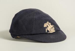 George Benjamin Street, Sussex & England 1909-1923. M.C.C. navy blue touring cap with embroidered emblem of St. George and the dragon, by E.C. Devereux of Eton, worn by Street on the M.C.C. tour of South Africa in 1922/23. &lsquo;G. Street&rsquo; handwritten in bla