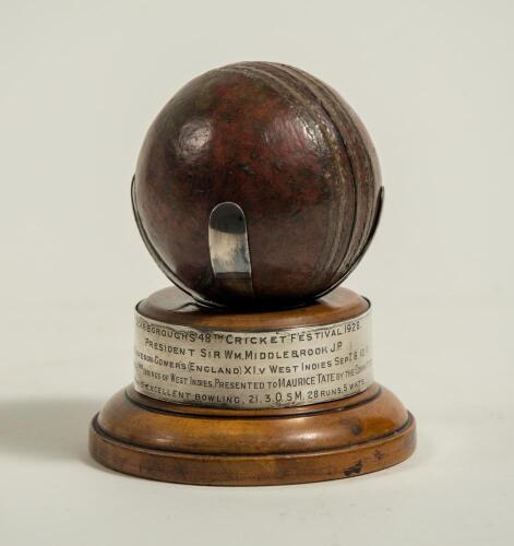 Maurice William Tate. Sussex & England 1912-1937. Cricket ball mounted to wooden stand with silver plaque running around the base of the stand with the inscription &lsquo;Scarborough&rsquo;s 48th Cricket Festival 1928. President Sir William Middlebrook. J.P. H.D.G. 