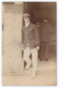 Gilbert Laird Jessop. Gloucestershire, Cambridge University & England 1894-1914. Early original sepia real photograph postcard of Jessop standing full length in a doorway wearing tour blazer and straw boater for A.C. MacLaren&rsquo;s tour to Australia 1901/02. 