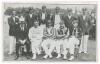 Hampshire C.C.C. 1912. Early original mono postcard of the Hampshire team that beat the touring Australians at Southampton, 22nd- 24th July 1912, the players seated and standing in rows wearing cricket attire, blazers and caps, spectators in the backgroun