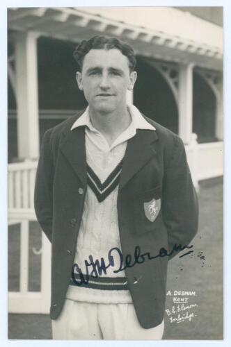 Alexander Frederick Henry Debnam. Kent & Hampshire 1948-1951. Mono real photograph plain back postcard of Debnam three quarter length in cricket attire and Kent blazer. Boldly signed in black ink to the photograph by Debnam. Printed title &lsquo;A. Debnam, Kent