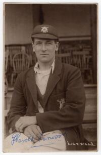 Harold Larwood. Nottinghamshire, Europeans & England 1924-1938. Original sepia real photograph postcard of Larwood seated wearing Nottinghamshire cap and blazer. Signed to the photograph in blue biro &lsquo;Harold Larwood&rsquo;, possibly in later years. Printed titl
