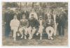 &lsquo;South of England XI v The Australian [sic]&rsquo; 1899. Rarer early sepia real photograph postcard of the South team seated and standing in rows wearing cricket attire, caps and blazers, for the opening match of the tour played at Crystal Palace, 8th- 10th May
