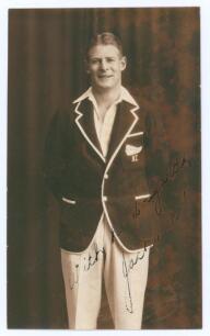 John Lambert &lsquo;Jack&rsquo; Kerr. Canterbury & New Zealand 1929-1940. Sepia real photograph plain back postcard of Kerr standing three quarter length wearing cricket attire and New Zealand blazer. Signed in ink with dedication, in part to the darker area of the p