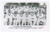 &lsquo;West Indies Cricket Touring Team 1950&rsquo;. Mono real photograph plain back postcard of the West Indies team seated and standing in rows wearing cricket attire, spectators in the background. Printed title and players&rsquo; names to lower border. Players include G