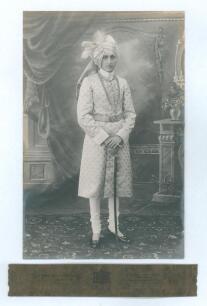 Iftikhar Khan Ali, Nawab of Pataudi. Oxford University, Worcestershire, India, England etc. 1928-1946. Excellent original mono full length studio portrait of Pataudi wearing ceremonial robes. Nicely signed in black ink to the darker area of the photograph
