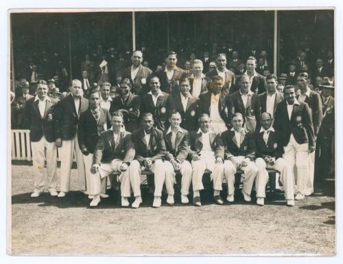 England v India, The Oval 1936. Original mono press photograph of the two teams together for the 3rd Test, 15th- 18th August 1936, in front of the pavilion with crowds looking on. The players seated and standing in rows wearing cricket attire and blazers.