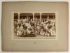 W.G. Grace at the cricket early 1900s. Large early original sepia photograph of a large group of cricketers and friends seated and standing in rows at the front of the Crystal Palace cricket pavilion in the early 1900s. Grace is depicted in the second row