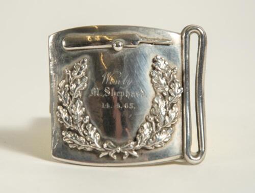 Cricket belt buckle. Silver metal cricket belt buckle of almost square form with laurel wreath garland to centre and cricket bat and ball above. Inscription to centre reads &lsquo;Won by M. Shephard&rsquo;. 14.4. [18]65. Approximately 2.5&rdquo;x2.25&rdquo;. Good condition