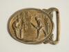 Cricket belt buckle. Brass cricket belt buckle of oval form with scene of a cricket match in progress to centre, batsman, wicket-keeper and fielders to foreground, trees to background. Approximately 2.75&rdquo;x2&rdquo;. Good condition