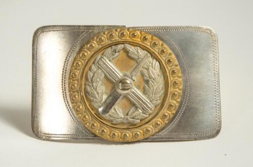 Cricket belt buckle. Two piece detachable silver metal belt buckle decorated to centre with gilt metal circular decoration with additional silver plate laurel wreath with crossed bat and stumps with cricket ball to centre, beaded border. Approximately 3.2