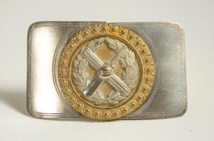 Cricket belt buckle. Two piece detachable silver metal belt buckle decorated to centre with gilt metal circular decoration with additional silver plate laurel wreath with crossed bat and stumps with cricket ball to centre, beaded border. Approximately 3.2