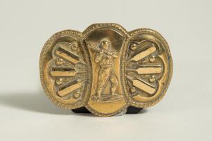 Cricket belt buckle. An attractive brass cricket belt buckle of oblong form with centre figure of a raised batsman playing a shot, to both sides are decorative cricket bats and balls in vertical patterns with floral design. Makers and registration mark to