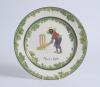 &lsquo;There&rsquo;s Style!&rsquo;. A Royal Doulton Black Boy dinner plate, entitled &lsquo;There&rsquo;s Style!&rsquo; printed with a boy in red jacket and a floppy hat stood in batting stance in front of the wicket. Green floral decoration to inner and outer rim. 9.5&rdquo; diameter. Doulton ba