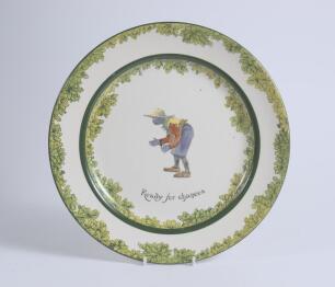 &lsquo;Ready for Chances&rsquo;. A Royal Doulton Black Boy dinner plate, entitled &lsquo;Ready for Chances&rsquo; printed with a boy in red shirt, yellow waistcoat and a floppy hat crouched awaiting a catch (as if in the slips). Green floral decoration to inner and outer rim. 10