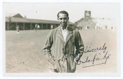 Kumar Shri Duleepsinhji. Sussex, Cambridge University & England 1924-1932. Original sepia real photograph plain back postcard of Duleep standing three quarter length at Scarborough, wearing striped blazer. Nicely signed in black ink to the photograph by D