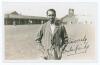 Kumar Shri Duleepsinhji. Sussex, Cambridge University & England 1924-1932. Original sepia real photograph plain back postcard of Duleep standing three quarter length at Scarborough, wearing striped blazer. Nicely signed in black ink to the photograph by D