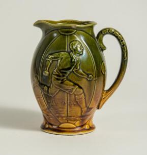 Football/Golf jug. Victorian ceramic jug with image of a footballer running with the ball to one side and a golfer and caddy to the other. Floral and bird decoration. The jug glazed in mustard and green. &lsquo;England&rsquo; to base. 6&rdquo; tall. Small chip to rim other