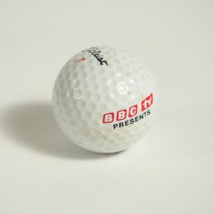 B.B.C. TV golf ball. Titleist golf ball with &lsquo;B.B.C. TV presents&rsquo; printed to it. Presumed to have been used either in the initial introduction or the ending of a golf television programme in the 1970&rsquo;s?. Good condition