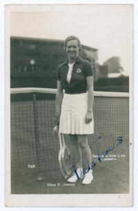 Winifred Alice &lsquo;Freda&rsquo; James. 1930s. Sepia real photograph postcard of James standing full length in tennis attire at the net. Very nicely signed in blue ink to the photograph &lsquo;Freda James&rsquo;. Printed title to lower edge. Published by E. Trim of Wimbledon, 