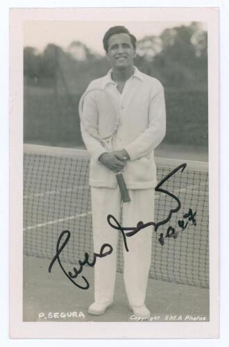 Francisco Olegario Segura Cano &lsquo;Pancho Segura&rsquo;. 1940s/1950s. Sepia real photograph plain back postcard of Segura standing full length in tennis attire at the net. Very nicely signed in black ink to the photograph &lsquo;Pancho Segura&rsquo; and dated 1947[?]. Printed