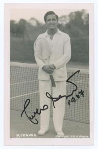 Francisco Olegario Segura Cano &lsquo;Pancho Segura&rsquo;. 1940s/1950s. Sepia real photograph plain back postcard of Segura standing full length in tennis attire at the net. Very nicely signed in black ink to the photograph &lsquo;Pancho Segura&rsquo; and dated 1947[?]. Printed