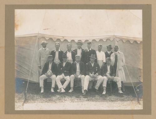 &lsquo;Australia Cricket Team. New Zealand Tour, 1913-1914&rsquo;. Excellent and rare large original mono photograph of the Australian touring party, seated and standing in rows, wearing cricket attire and blazers in front of a large marquee. Players are Arthur Simms