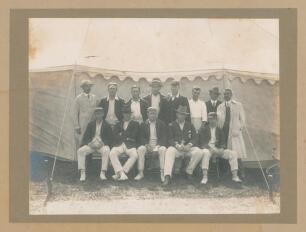 &lsquo;Australia Cricket Team. New Zealand Tour, 1913-1914&rsquo;. Excellent and rare large original mono photograph of the Australian touring party, seated and standing in rows, wearing cricket attire and blazers in front of a large marquee. Players are Arthur Simms