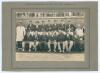 M.C.C. tour to Australia 1920/21. Official sepia photograph of the M.C.C. touring party seated and standing in rows wearing cricket attire and blazers. Laid down to photographer&rsquo;s mount with printed title to upper border, &lsquo;With the compliments of &ldquo;The Dai
