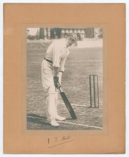 Vernon Tickell Hill. Somerset 1891-1912. Excellent mounted photograph of Hill posed at the wicket, wearing Oxford University cap. The photograph laid down to photographers mount and signed by Hill to lower border. Overall 9.75&rdquo;x12&rdquo;. Good condition