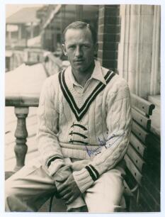Robert Walter Vivian Robins. Cambridge University, Middlesex & England 1926-1951. Original mono photograph of Robins, three quarter length in cricket attire sat in front of a pavilion, probably Lord&rsquo;s. Signed by Robins to photograph. The photograph measur