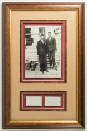 M.C.C. Tour of Australia &lsquo;Bodyline&rsquo; 1932/33. Bill Voce and Harold Larwood. Excellent mono photograph of the two players on board ship wearing suits and ties outside the &lsquo;Wireless Office&rsquo;. Attractively mounted with the individual ink signatures of both pl