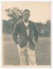 Thomas William John Goddard. Gloucestershire & England 1922-1952. Excellent mono photograph of Goddard, wearing Gloucestershire blazer and cricket attire. Nicely signed in ink by Goddard. The photograph by H.K. Fox of Gloucester. 6&rdquo;x8&rdquo;. Very minor silveri