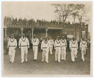 All India tour to England 1936. Large original mono press photograph depicting the Indian team being led on to the field by captain Maharai Kumar of Vizianagram for the opening match of the 1936 tour v A.P. [Tich] Freeman&rsquo;s XI at the Bat and Ball Ground,