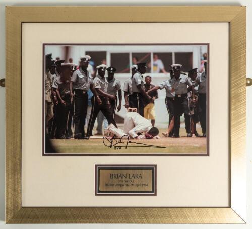 &lsquo;Brian Lara 375 not out. 5th Test, Antigua, April 1994&rsquo;. Large colour photograph of Lara bent down on his knees to kiss the turf of the Antigua Recreation Ground having achieved the historic event. Signed to image by Lara &lsquo;375&rsquo;. Attractively mounted, fram