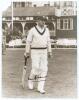 Don Bradman. A nice high quality sepia tone copy photograph of Bradman walking out to bat with the pavilion and deckchairs in the background. Ground and tour not known. Nicely signed in bold ink by Bradman in later years. 10&rdquo;x8&rdquo;. Very good condition.