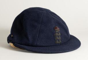 Hedley Verity. Yorkshire & England 1930-1939. England navy blue cloth Test cap with raised wired emblem of the three lions and crown to front. The cap made by E.C. Devereux of Eton, Bucks with &lsquo;H. Verity&rsquo; handwritten in black ink to inner label of cap. Od