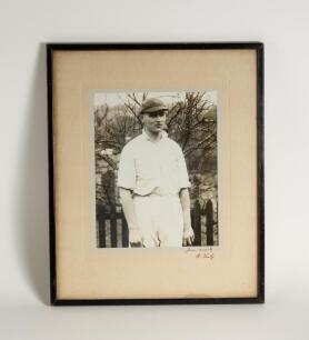 Hedley Verity, Yorkshire & England, 1930-39. Excellent large original mono photograph of Verity, three quarter length, wearing cricket attire and proudly wearing his England cap standing in front of a picket fence. Very nicely signed &lsquo;Yours sincerely H. V